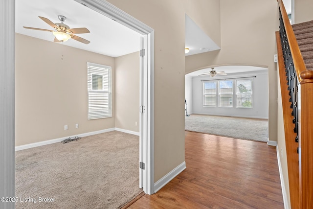 9006 Big Boulder Dr, Louisville, KY 40291 - carpeted empty room with a ceiling fan, arched walkways, healthy amount of natural light, and stairs