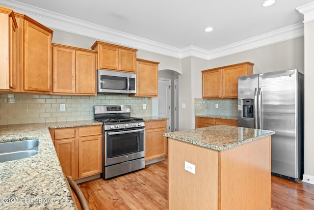 9006 Big Boulder Dr, Louisville, KY 40291 - kitchen with appliances with stainless steel finishes, light wood finished floors, a center island, ornamental molding, and light stone counters