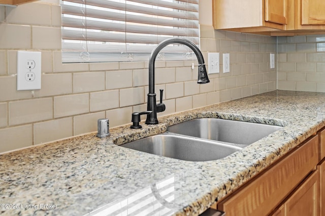 9006 Big Boulder Dr, Louisville, KY 40291 - kitchen view of backsplash, light stone countertops, and brown cabinets