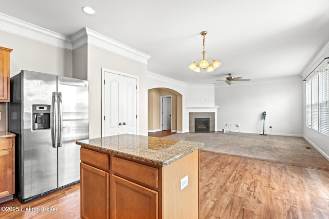 9006 Big Boulder Dr, Louisville, KY 40291 - kitchen with stainless steel fridge with ice dispenser, a ceiling fan, arched walkways, a kitchen island, and pendant lighting