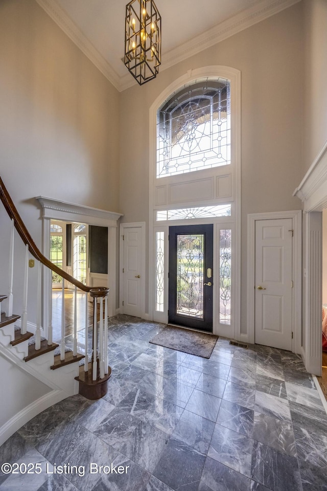 7202 Doe Crest Ct, Prospect, KY 40059 - foyer featuring a high ceiling, stairs, a chandelier, marble tiled flooring, and crown molding
