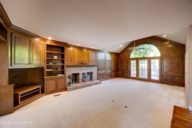 7202 Doe Crest Ct, Prospect, KY 40059 - unfurnished living room featuring a brick fireplace, vaulted ceiling, a decorative wall, and carpet