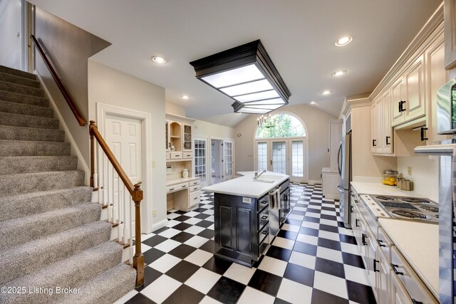 7202 Doe Crest Ct, Prospect, KY 40059 - kitchen with dark flooring, light countertops, an island with sink, vaulted ceiling, and recessed lighting