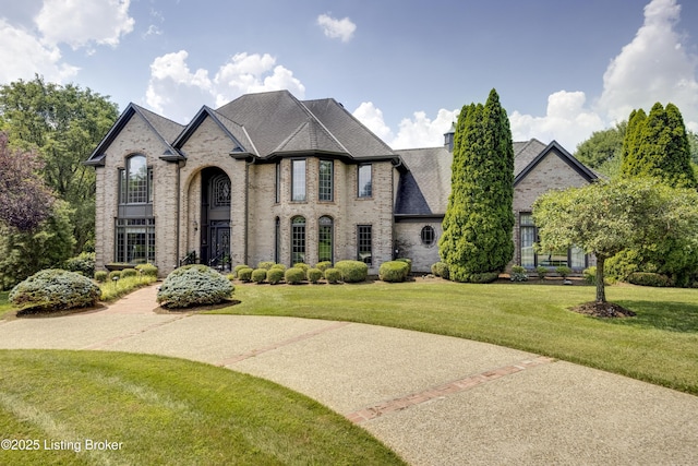 7202 Doe Crest Ct, Prospect, KY 40059 - french country home with brick siding, a front yard, and a chimney