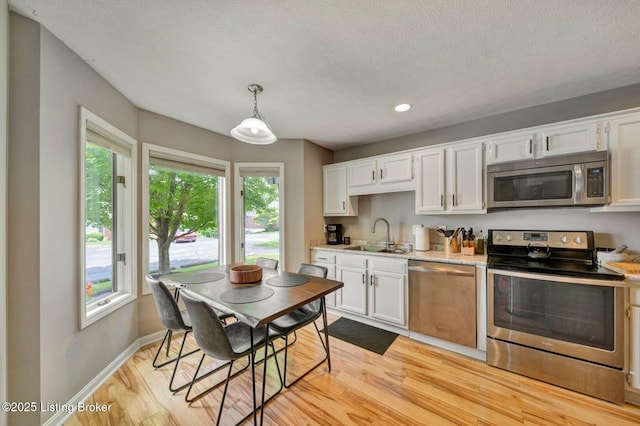 5503 Forest Lake Dr, Prospect, KY 40059 - kitchen with stainless steel appliances, light countertops, white cabinetry, recessed lighting, and plenty of natural light