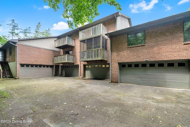 5503 Forest Lake Dr, Prospect, KY 40059 - back of house featuring brick siding, driveway, and an attached garage