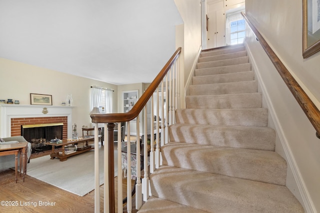 2628 Landor Ave, Louisville, KY 40205 - staircase featuring wood finished floors and a brick fireplace