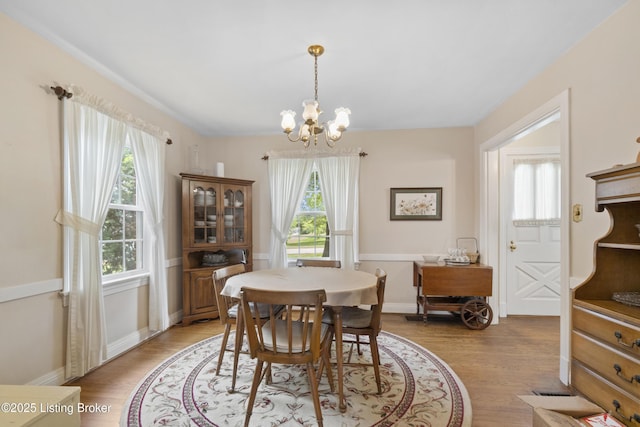 2628 Landor Ave, Louisville, KY 40205 - dining room with healthy amount of natural light, a chandelier, and light wood-style flooring