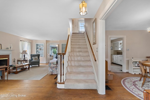 2628 Landor Ave, Louisville, KY 40205 - stairs featuring wood finished floors, healthy amount of natural light, a fireplace, and built in features