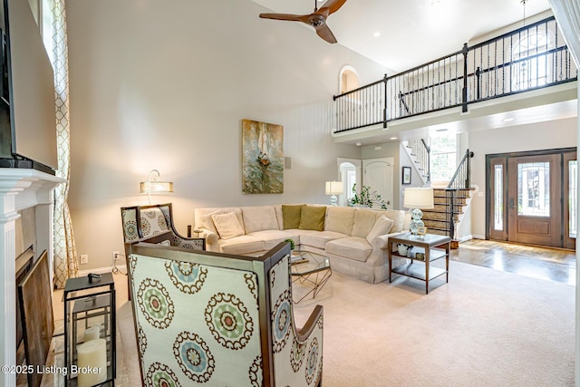 17503 Polo Run Ln, Louisville, KY 40245 - living room with a high ceiling, a ceiling fan, stairway, a fireplace, and carpet floors