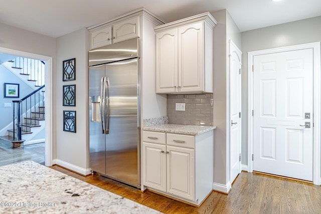 17503 Polo Run Ln, Louisville, KY 40245 - kitchen with stainless steel built in fridge, wood finished floors, tasteful backsplash, and light stone counters