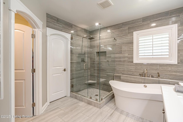 17503 Polo Run Ln, Louisville, KY 40245 - full bath with a shower stall, a freestanding tub, and tile walls