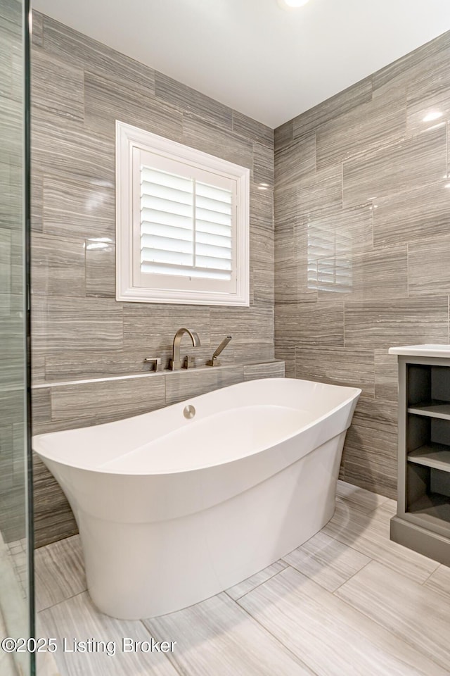 17503 Polo Run Ln, Louisville, KY 40245 - bathroom featuring tile walls and a freestanding tub