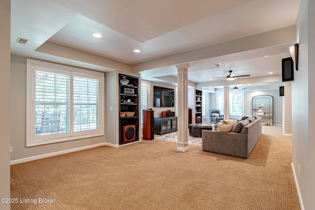 17503 Polo Run Ln, Louisville, KY 40245 - living area with light carpet, a ceiling fan, a raised ceiling, recessed lighting, and ornate columns