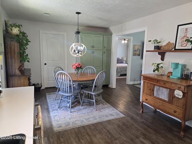 306 Butler Dr, Bardstown, KY 40004 - dining area with dark wood-style floors, a chandelier, and a textured ceiling