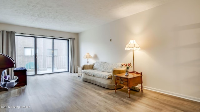 3030 Breckenridge Ln Apt 201, Louisville, KY 40220 - sitting room featuring wood finished floors and a textured ceiling