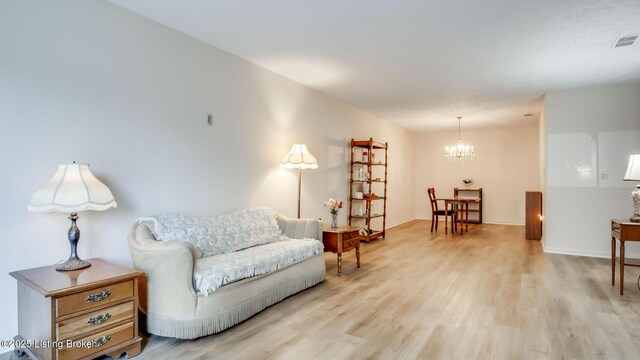 3030 Breckenridge Ln Apt 201, Louisville, KY 40220 - living area with a chandelier and light wood-type flooring