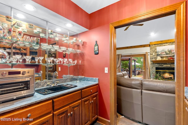509 Oak Branch Rd, Louisville, KY 40245 - indoor wet bar featuring a fireplace and a ceiling fan