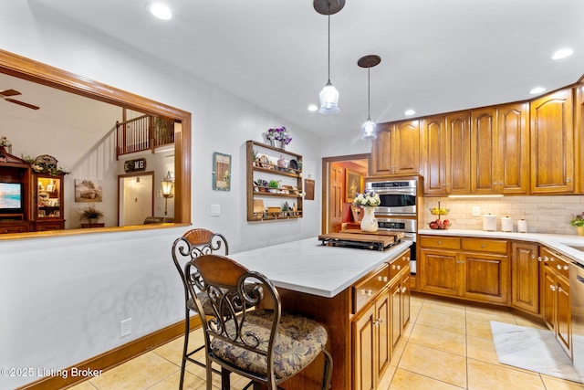509 Oak Branch Rd, Louisville, KY 40245 - kitchen with recessed lighting, light tile patterned flooring, decorative backsplash, appliances with stainless steel finishes, and brown cabinetry