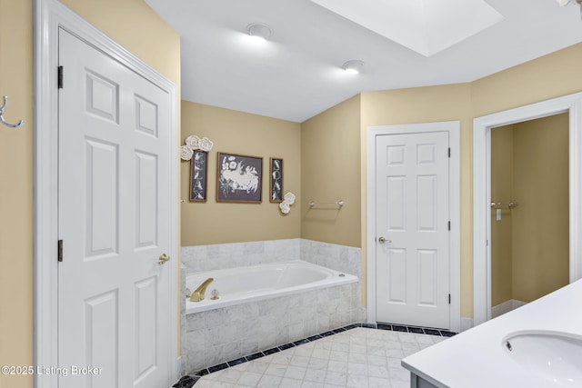 509 Oak Branch Rd, Louisville, KY 40245 - bathroom featuring a garden tub, vanity, a skylight, and tile patterned flooring
