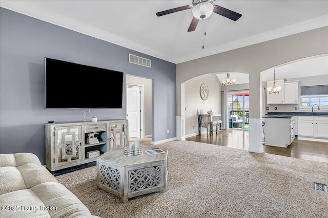 1105 Deer Fields Trce, La Grange, KY 40031 - carpeted living room with arched walkways, a chandelier, ceiling fan, and ornamental molding