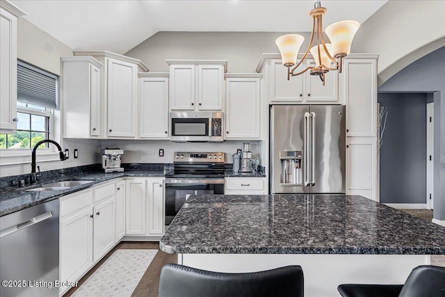 1105 Deer Fields Trce, La Grange, KY 40031 - kitchen with appliances with stainless steel finishes, lofted ceiling, arched walkways, a kitchen bar, and white cabinets