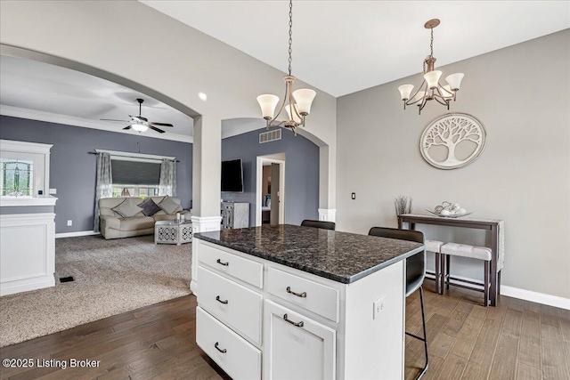 1105 Deer Fields Trce, La Grange, KY 40031 - kitchen featuring a chandelier, arched walkways, a center island, a kitchen bar, and white cabinets