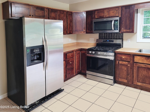 1707 N Stillwell Rd, Boston, KY 40107 - kitchen featuring stainless steel appliances, light countertops, and light tile patterned flooring