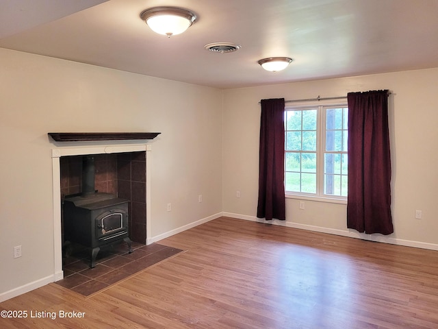 1707 N Stillwell Rd, Boston, KY 40107 - unfurnished living room featuring wood finished floors and a wood stove