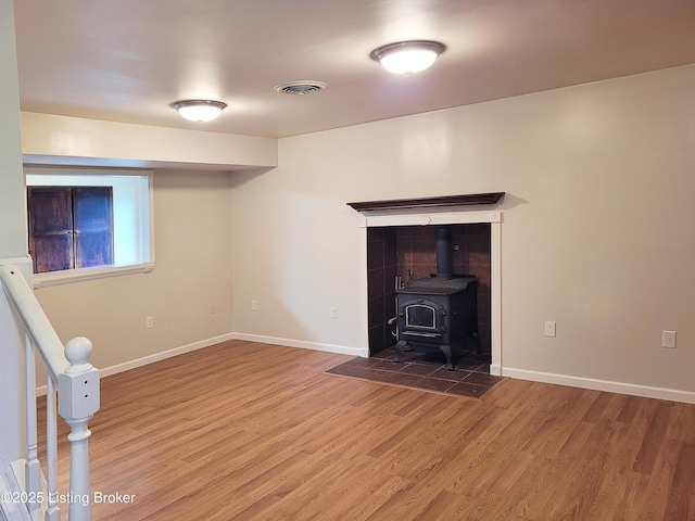1707 N Stillwell Rd, Boston, KY 40107 - unfurnished living room featuring wood finished floors and a wood stove