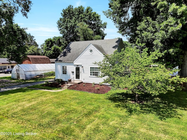 7248 Beechland Ave, Louisville, KY 40258 - view of front of house featuring a greenhouse, a front yard, an outdoor structure, and roof with shingles