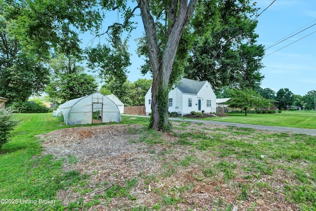 7248 Beechland Ave, Louisville, KY 40258 - view of green lawn with a greenhouse and an outbuilding