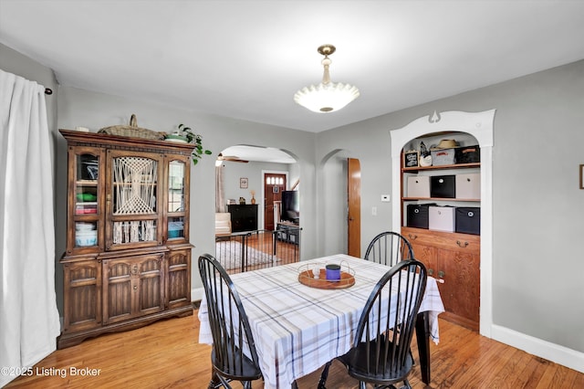 7248 Beechland Ave, Louisville, KY 40258 - dining area with arched walkways and light wood-style flooring