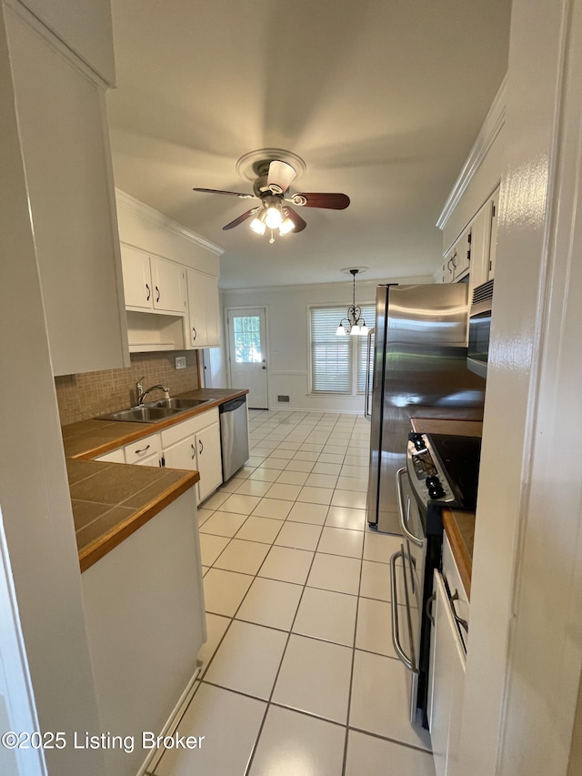 2804 Creekside Dr, Louisville, KY 40241 - kitchen with appliances with stainless steel finishes, ceiling fan, crown molding, white cabinetry, and light tile patterned floors