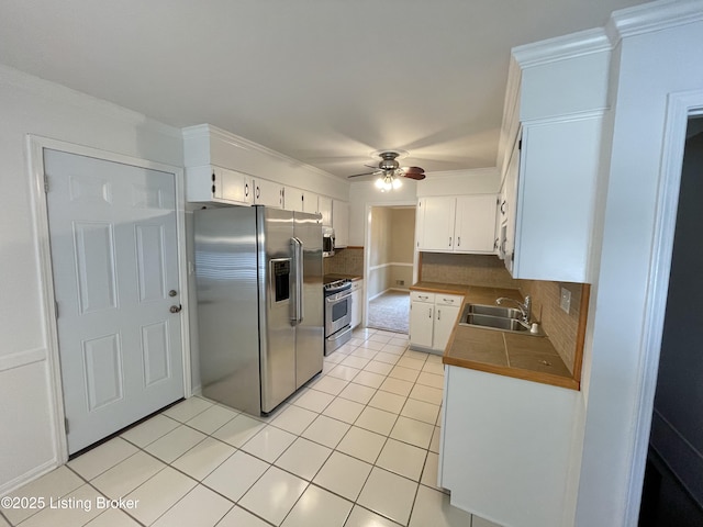 2804 Creekside Dr, Louisville, KY 40241 - kitchen featuring stainless steel appliances, a ceiling fan, tasteful backsplash, light tile patterned flooring, and white cabinets