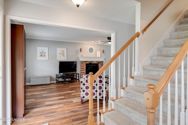 1403 Cadence Ct, Louisville, KY 40222 - stairs with a ceiling fan, wood finished floors, ornamental molding, and a brick fireplace