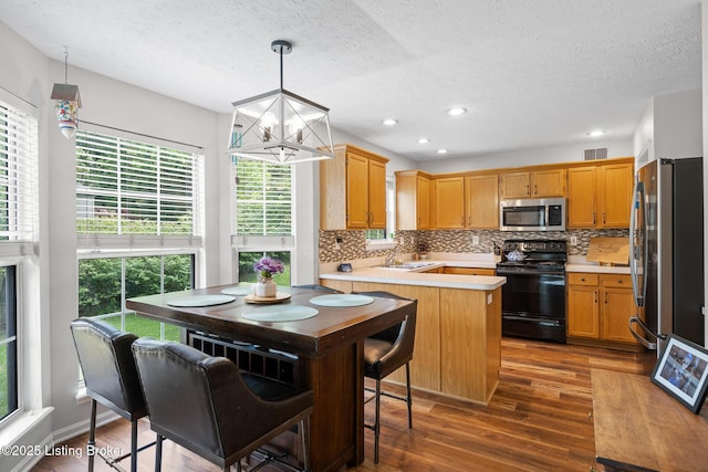 1403 Cadence Ct, Louisville, KY 40222 - kitchen with appliances with stainless steel finishes, a textured ceiling, plenty of natural light, backsplash, and light countertops