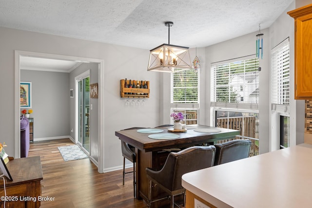 1403 Cadence Ct, Louisville, KY 40222 - dining area with a chandelier, wood finished floors, a textured ceiling, and crown molding