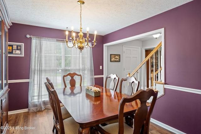 1403 Cadence Ct, Louisville, KY 40222 - dining room featuring a chandelier, a textured ceiling, wood finished floors, and stairway