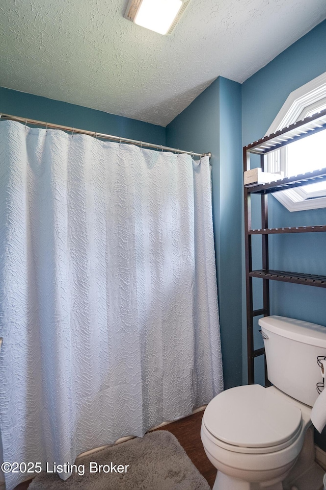 1403 Cadence Ct, Louisville, KY 40222 - bathroom featuring a textured ceiling, wood finished floors, and curtained shower