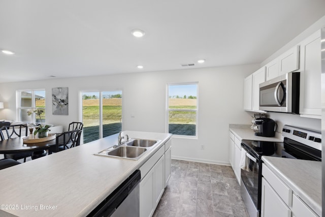 1520 Robin Rd, Shelbyville, KY 40065 - kitchen with stainless steel appliances, light countertops, white cabinetry, and recessed lighting