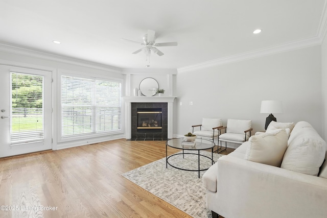 3416 Sasse Way, Louisville, KY 40245 - living room featuring plenty of natural light, a ceiling fan, wood finished floors, ornamental molding, and a tile fireplace