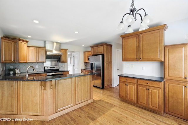 3416 Sasse Way, Louisville, KY 40245 - kitchen featuring stainless steel appliances, wall chimney range hood, a peninsula, light wood finished floors, and dark stone counters