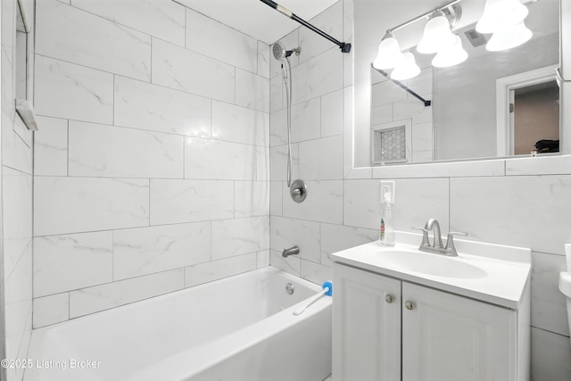 940 Dixie Hwy, Louisville, KY 40210 - bathroom featuring vanity, tub / shower combination, and tile walls