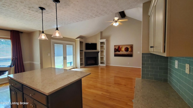 4318 Juniper Forest Pl, Louisville, KY 40245 - kitchen featuring light wood-type flooring, a ceiling fan, open floor plan, pendant lighting, and vaulted ceiling