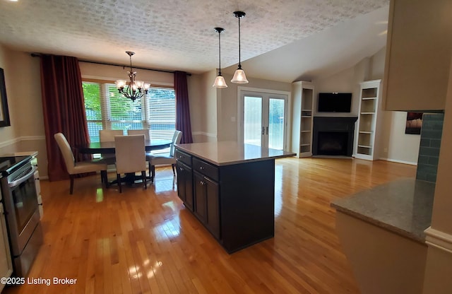 4318 Juniper Forest Pl, Louisville, KY 40245 - kitchen featuring stainless steel electric stove, light wood finished floors, a chandelier, decorative light fixtures, and a fireplace