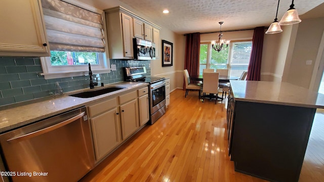 4318 Juniper Forest Pl, Louisville, KY 40245 - kitchen featuring stainless steel appliances, tasteful backsplash, a chandelier, decorative light fixtures, and light wood-style flooring