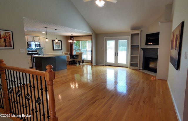 4318 Juniper Forest Pl, Louisville, KY 40245 - living area with light wood-type flooring, a fireplace with flush hearth, a ceiling fan, high vaulted ceiling, and a chandelier