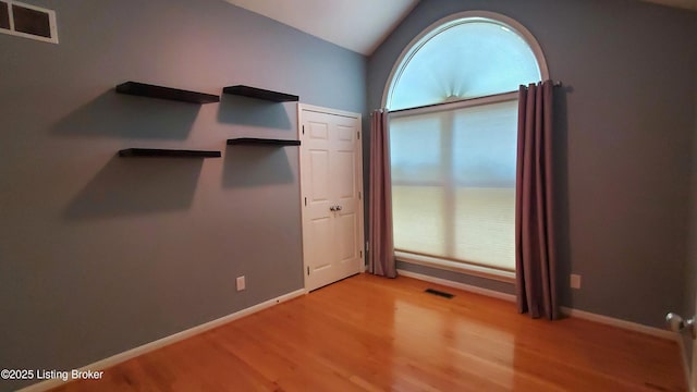 4318 Juniper Forest Pl, Louisville, KY 40245 - unfurnished bedroom with light wood-style floors and vaulted ceiling
