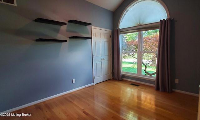 4318 Juniper Forest Pl, Louisville, KY 40245 - unfurnished bedroom featuring light wood-style flooring and vaulted ceiling